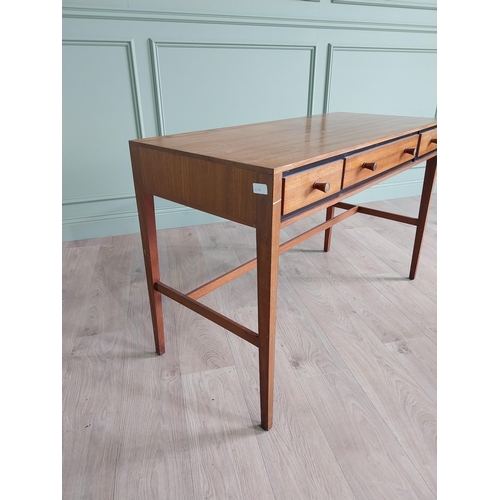 1133 - Mid-century teak desk with three drawers raised on square tapered legs and single stretcher {75 cm H... 