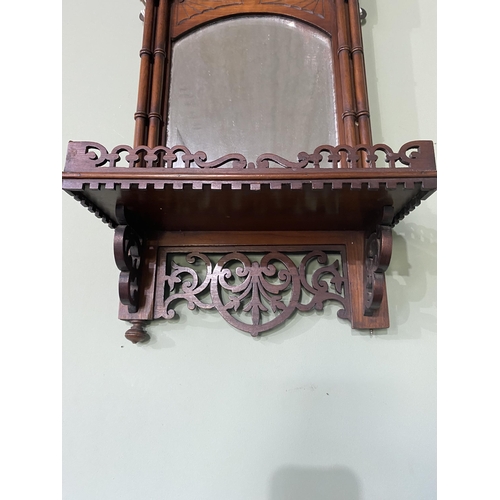 102 - Edwardian mahogany wall shelf with mirror backed in the Chippendale style {63 cm H x 31 cm W x 16 cm... 