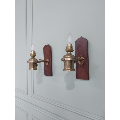 1020 - Pair of good quality ships lamps mounted on mahogany plaques {30 cm H x 10 cm W x 24 cm D}.