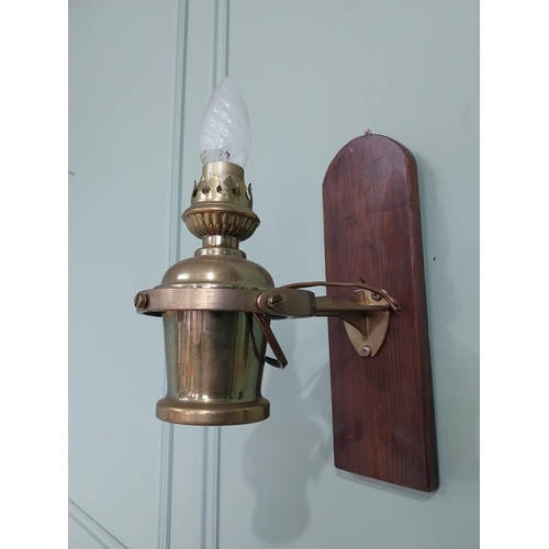 1020 - Pair of good quality ships lamps mounted on mahogany plaques {30 cm H x 10 cm W x 24 cm D}.