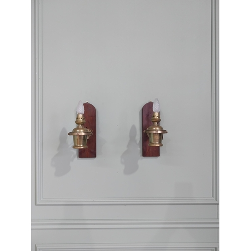 1020 - Pair of good quality ships lamps mounted on mahogany plaques {30 cm H x 10 cm W x 24 cm D}.