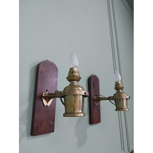 1020 - Pair of good quality ships lamps mounted on mahogany plaques {30 cm H x 10 cm W x 24 cm D}.