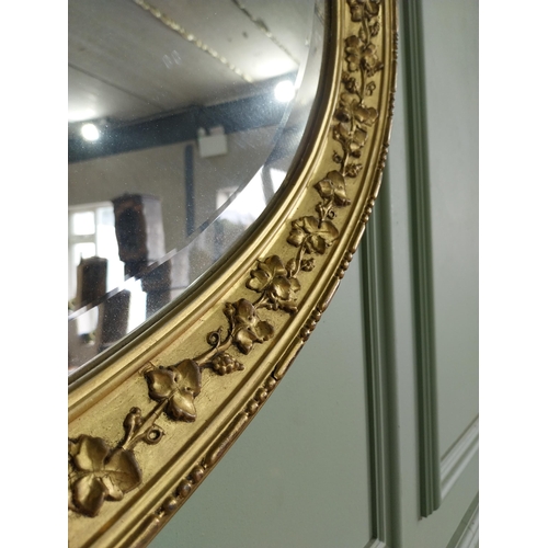 1023 - 19th C. giltwood oval wall mirror decorated with grape vines {67 cm H x 97 cm W}.