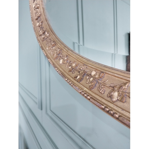 1023 - 19th C. giltwood oval wall mirror decorated with grape vines {67 cm H x 97 cm W}.