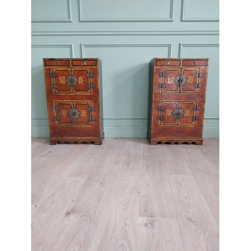 1043 - Pair of Oriental side cabinets with two drawers in the frieze above four blind doors and brass mount... 