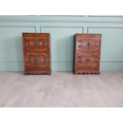 1043 - Pair of Oriental side cabinets with two drawers in the frieze above four blind doors and brass mount... 