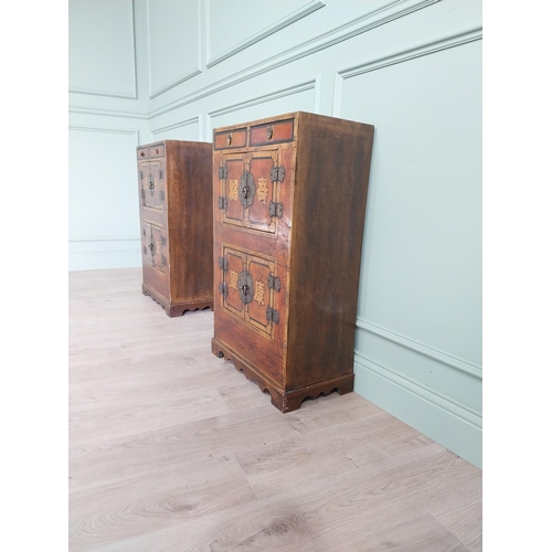 1043 - Pair of Oriental side cabinets with two drawers in the frieze above four blind doors and brass mount... 