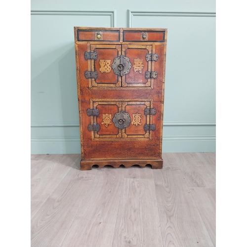 1043 - Pair of Oriental side cabinets with two drawers in the frieze above four blind doors and brass mount... 