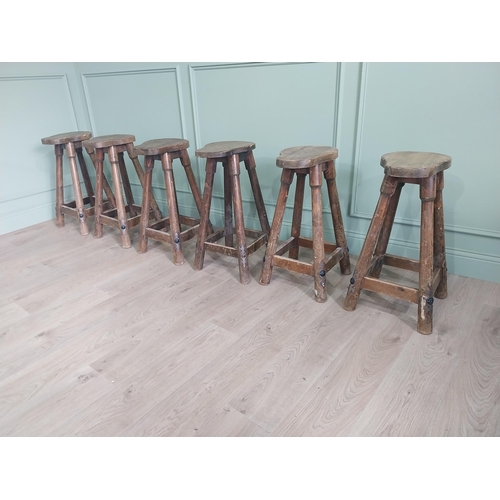 1055 - Set of six vintage pine counter stools with saddle seat raised on circular splayed legs {68 cm H x 6... 