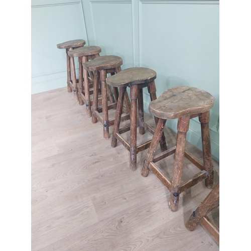 1055 - Set of six vintage pine counter stools with saddle seat raised on circular splayed legs {68 cm H x 6... 