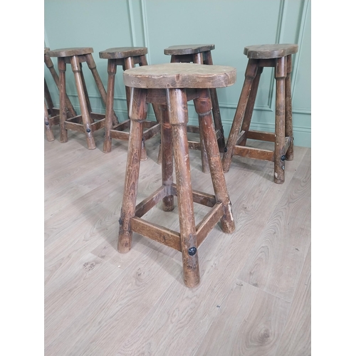 1055 - Set of six vintage pine counter stools with saddle seat raised on circular splayed legs {68 cm H x 6... 