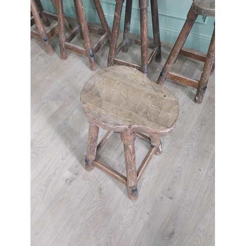 1055 - Set of six vintage pine counter stools with saddle seat raised on circular splayed legs {68 cm H x 6... 