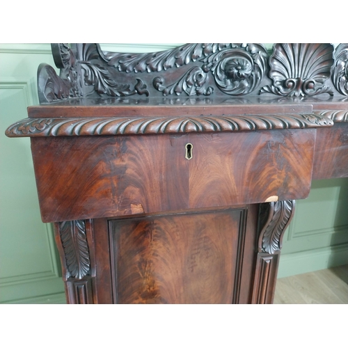 107 - Irish profusely carved mahogany sideboard with gallery decorated with central shell raised on brass ... 