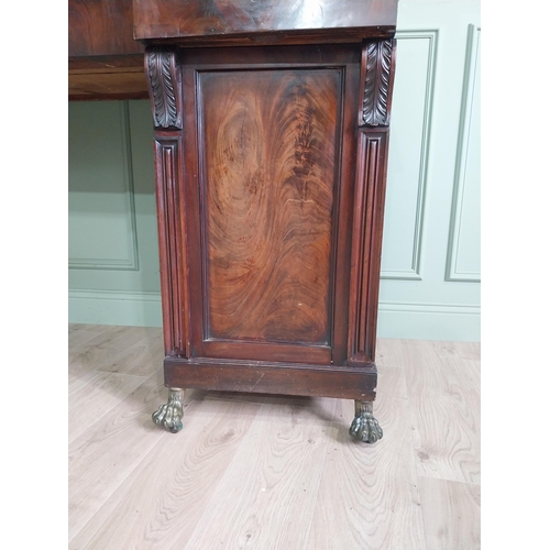 107 - Irish profusely carved mahogany sideboard with gallery decorated with central shell raised on brass ... 