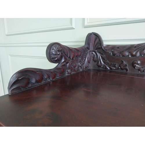 107 - Irish profusely carved mahogany sideboard with gallery decorated with central shell raised on brass ... 