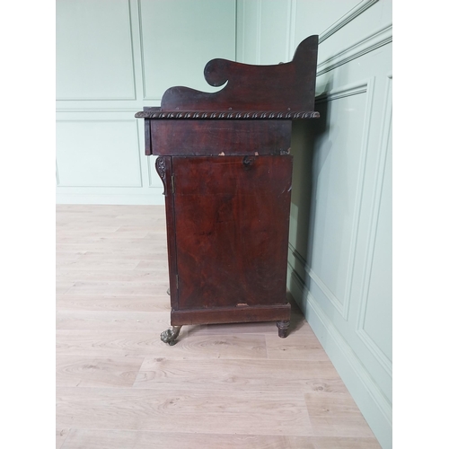 107 - Irish profusely carved mahogany sideboard with gallery decorated with central shell raised on brass ... 