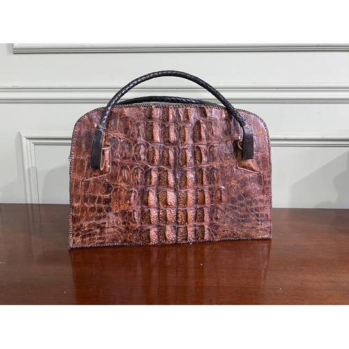 1070 - Early 20th C. crocodile leather hand bag {27 cm H x 40 cm W x 14 cm D}.