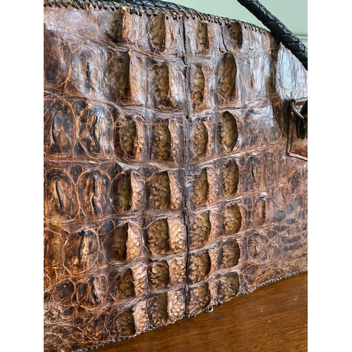 1070 - Early 20th C. crocodile leather hand bag {27 cm H x 40 cm W x 14 cm D}.