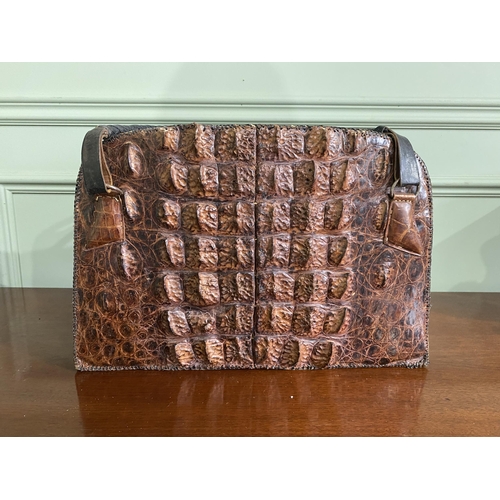 1070 - Early 20th C. crocodile leather hand bag {27 cm H x 40 cm W x 14 cm D}.