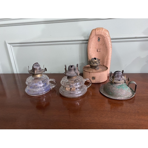 1075 - Three early 20th C. glass and metal thumb lamps and one wall mounted oil lamp {26 cm H x 14 cm W x 1... 