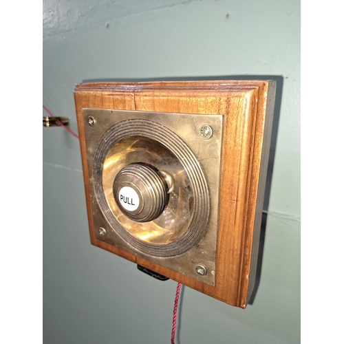 1076 - Butlers brass door bell mounted on wooden plaque. - NOT AVAILABLE TO VIEW IN PERSON