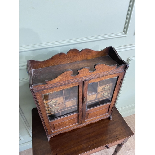 1136 - Good quality Edwardian oak smokers cabinet with two glazed doors and fitted interior {62 cm H x 54 c... 