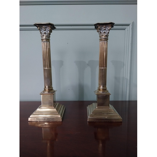 115 - Neat pair of early 19th C. brass Corinthian topped candlesticks {Approx. 29 cm H x 10 cm Dia.}.