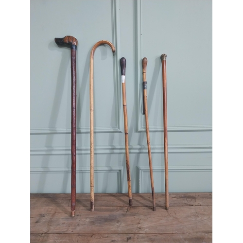 1152 - Collection of five 19th & 20th C. walking canes - one with brass mount decorated with Shamrocks.