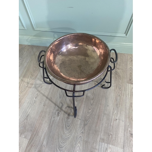 121 - 19th C. copper preserving pan raised on wrought iron stand {47 cm H x 65 cm Dia.}.