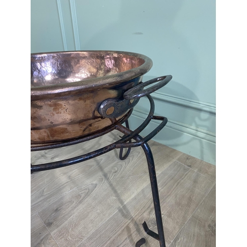 121 - 19th C. copper preserving pan raised on wrought iron stand {47 cm H x 65 cm Dia.}.