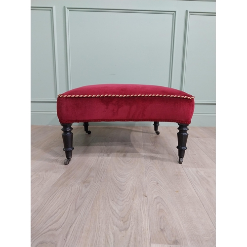 1213 - 19th C. French upholstered footstool raised on ebonised turned legs and brass castors {37 cm H x 68 ... 