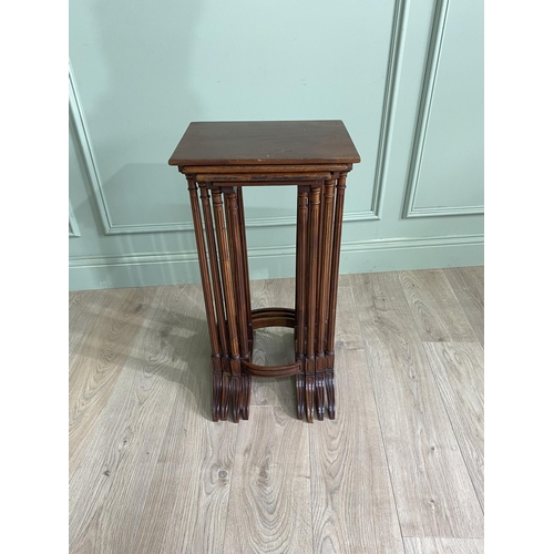 1216 - Edwardian mahogany nest of four tables raised on reeded legs {70 cm H x 35 cm W  x 26 cm D}.