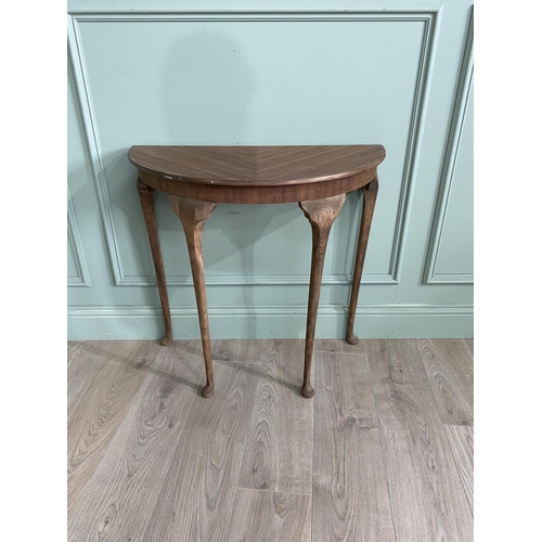 1219 - Mahogany demi-lune side table raised on cabriole legs {72 cm H x 75 cm D x 38 cm D}.