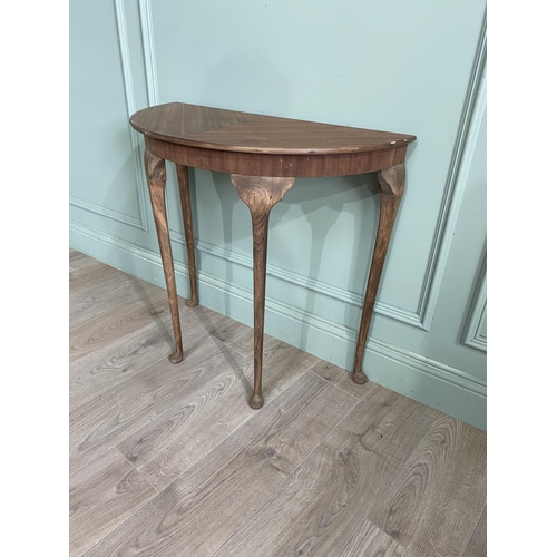 1219 - Mahogany demi-lune side table raised on cabriole legs {72 cm H x 75 cm D x 38 cm D}.