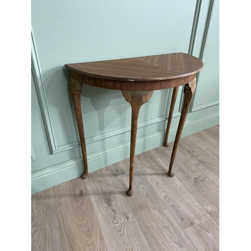 1219 - Mahogany demi-lune side table raised on cabriole legs {72 cm H x 75 cm D x 38 cm D}.