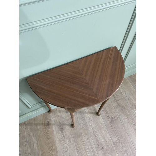 1219 - Mahogany demi-lune side table raised on cabriole legs {72 cm H x 75 cm D x 38 cm D}.