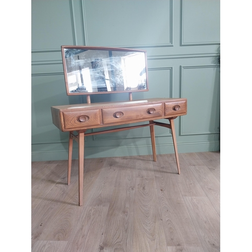 1227 - Oak Ercol dressing table with three drawers in the frieze raised on square tapered legs {124 x 115 x... 