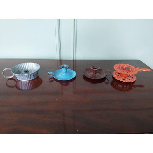 1250 - Three early 20th C. thumb candleholders and a cast iron trivet.