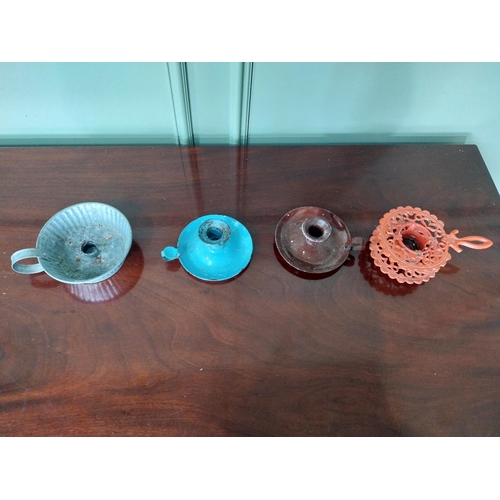 1250 - Three early 20th C. thumb candleholders and a cast iron trivet.