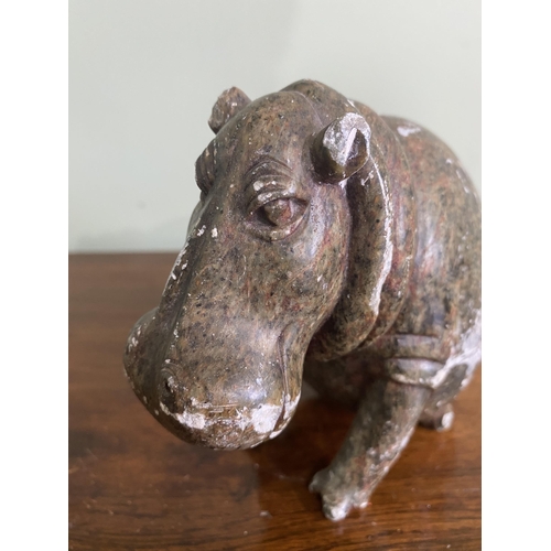 1254 - Carved soap stone statuette of a seated Hippopotamus {13 cm H x 8 cm W x 14 cm D}.