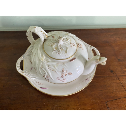 1268 - Belleek plate and teapot {3 cm H x 29 cm W x 25 cm D and 13 cm H x 23 cm W x 18 cm D}.