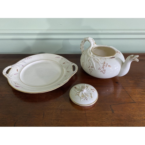 1268 - Belleek plate and teapot {3 cm H x 29 cm W x 25 cm D and 13 cm H x 23 cm W x 18 cm D}.