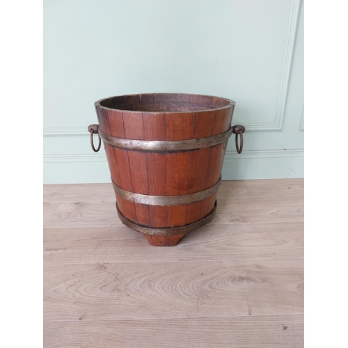 127 - Good quality Edwardian metal bound oak log bucket with wrought iron handles {43 cm H x 54 cm Dia.}.