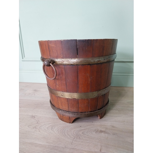 127 - Good quality Edwardian metal bound oak log bucket with wrought iron handles {43 cm H x 54 cm Dia.}.