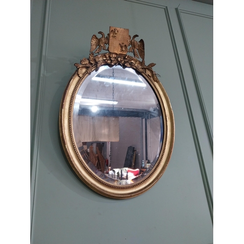 1285 - 19th C. French giltwood oval wall mirror decorated with crest flanked by eagles {98 cm H x 55 cm W}.