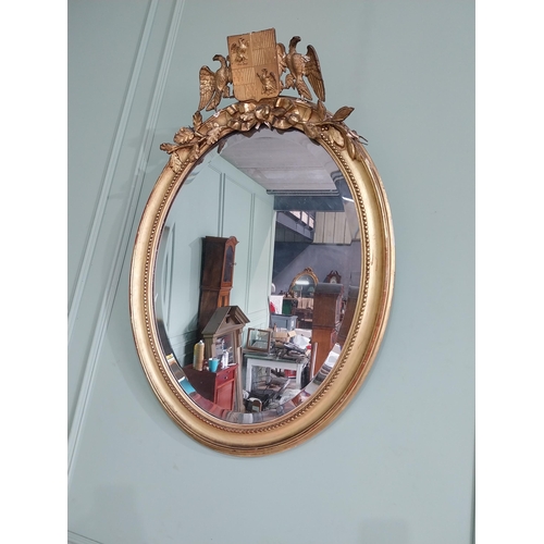 1285 - 19th C. French giltwood oval wall mirror decorated with crest flanked by eagles {98 cm H x 55 cm W}.