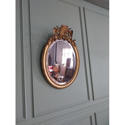 1285 - 19th C. French giltwood oval wall mirror decorated with crest flanked by eagles {98 cm H x 55 cm W}.