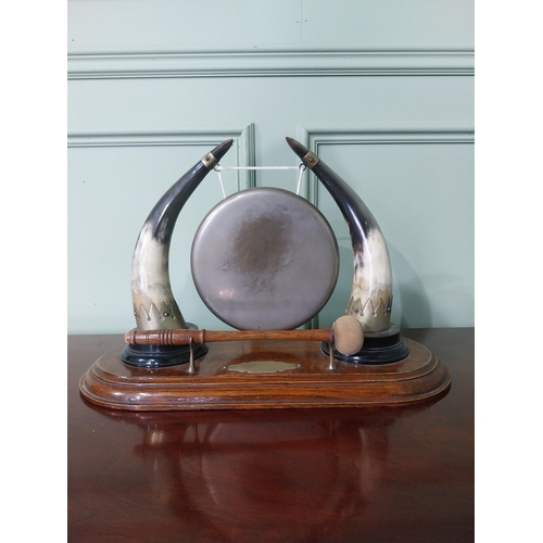 129 - Early 20th C. dinner gong made from cow horns and silver plate mounts mounted on oak plinth {33 cm H... 