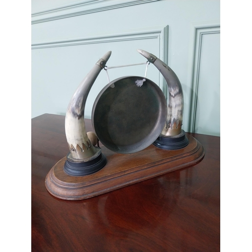 129 - Early 20th C. dinner gong made from cow horns and silver plate mounts mounted on oak plinth {33 cm H... 