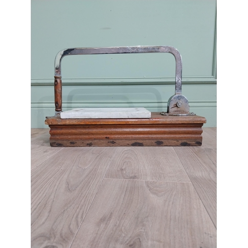 13 - Chrome and marble cheese cutter mounted on mahogany base {77 cm H x 60 cm W x 22 cm D}.